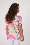 Woman wearing a colorful abstract patterned shirt on a white background Life Top Pink