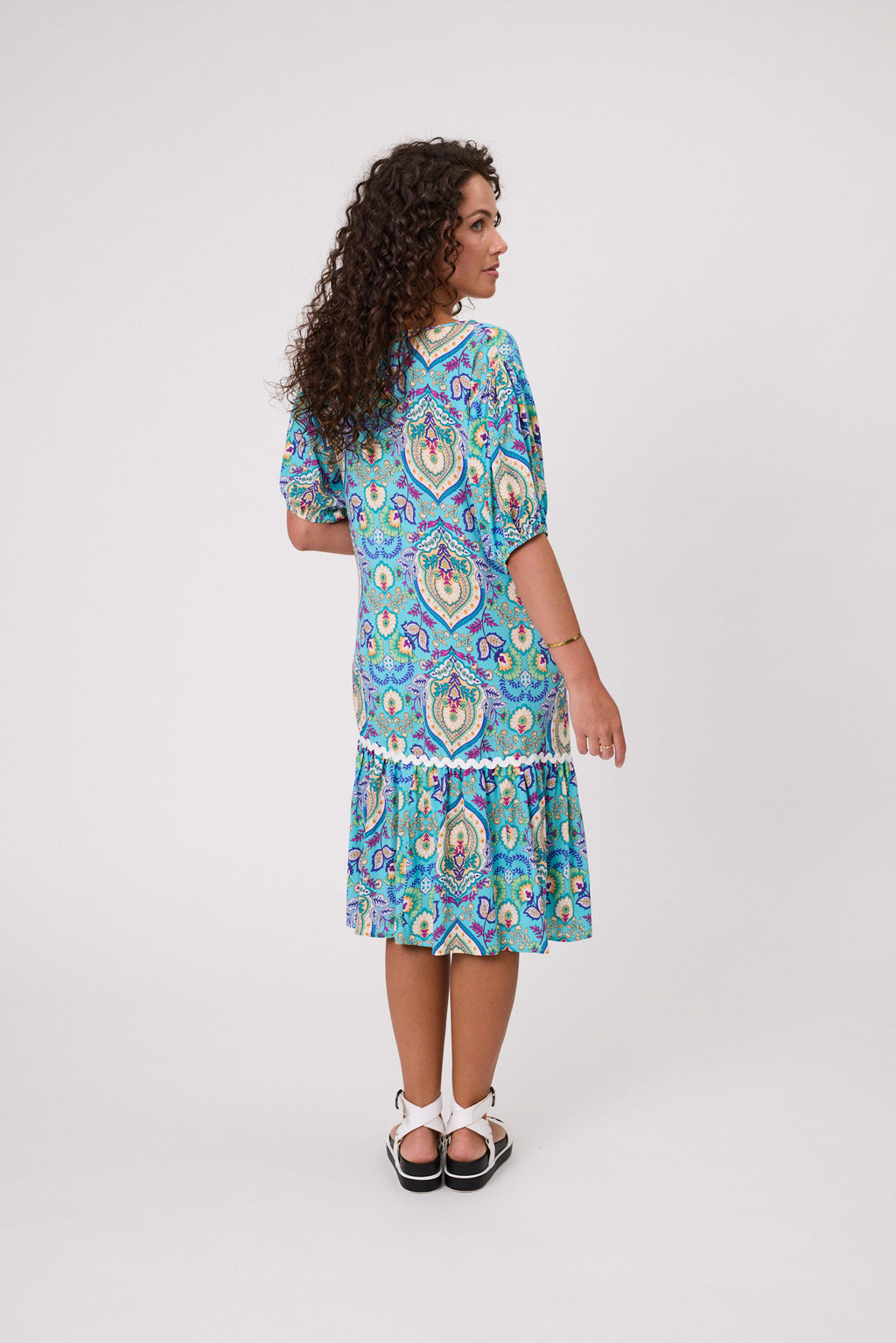 Woman wearing a blue patterned dress on a white background Salerno Printed Dress Aqua