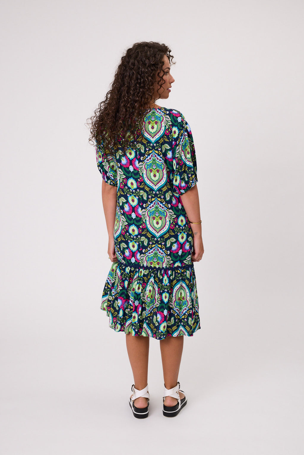 Woman wearing a colorful patterned dress on a white background Salerno Printed Dress Navy