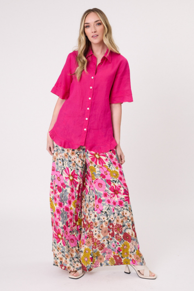 Woman wearing a bright pink shirt and floral pants on a white background
Camilla Linen Top Fuchsia