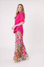 Woman wearing a bright pink top and floral pants on a white background
Camilla Linen Top Fuchsia