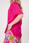 Person wearing a bright pink top and floral skirt against a white background
Camilla Linen Top Fuchsia