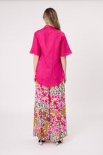 Person wearing a bright pink shirt and floral pants on a white background
Camilla Linen Top Fuchsia