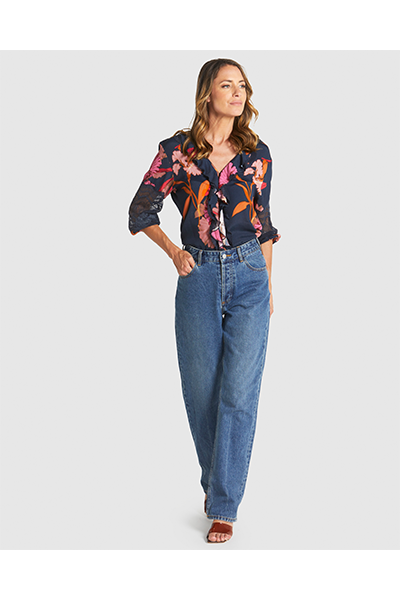 Woman wearing a floral blouse and blue jeans on a white background
Captivation Shirt Navy Floral