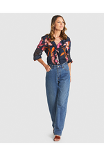 Woman wearing a floral blouse and blue jeans on a white background
Captivation Shirt Navy Floral