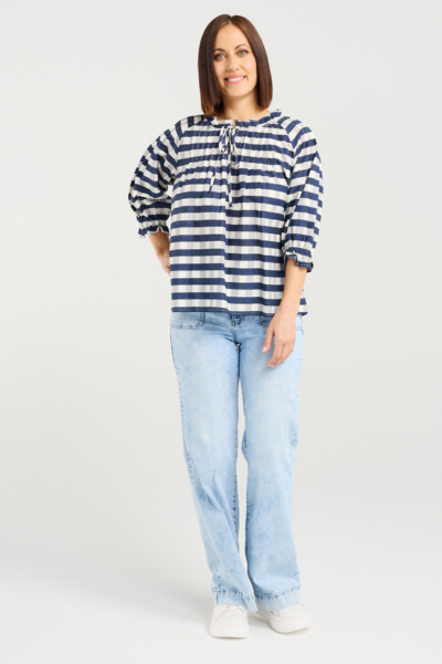 Woman wearing a blue and white striped shirt and light blue jeans on a white background Claire Top Ink Check