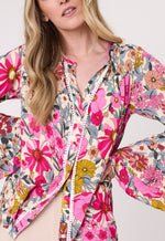 Woman wearing a colorful floral jacket on a white background
Contessa Top Garden Print