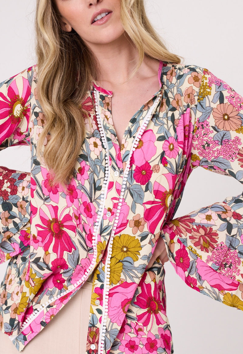 Woman wearing a colorful floral jacket on a white background
Contessa Top Garden Print
