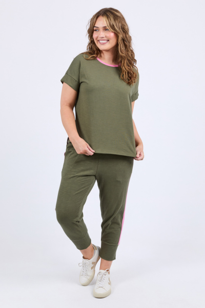 Woman wearing a green outfit with a white background
Cooper Tee Clover Green
