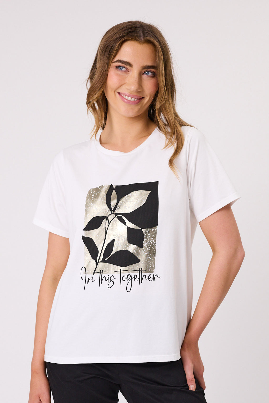 Woman wearing a white t-shirt with a black and gray leaf design and 'In this together' text on a white background In This Together T-Shirt White