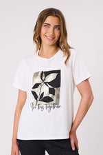 Woman wearing a white t-shirt with a black and gray leaf design and 'In this together' text on a white background In This Together T-Shirt White