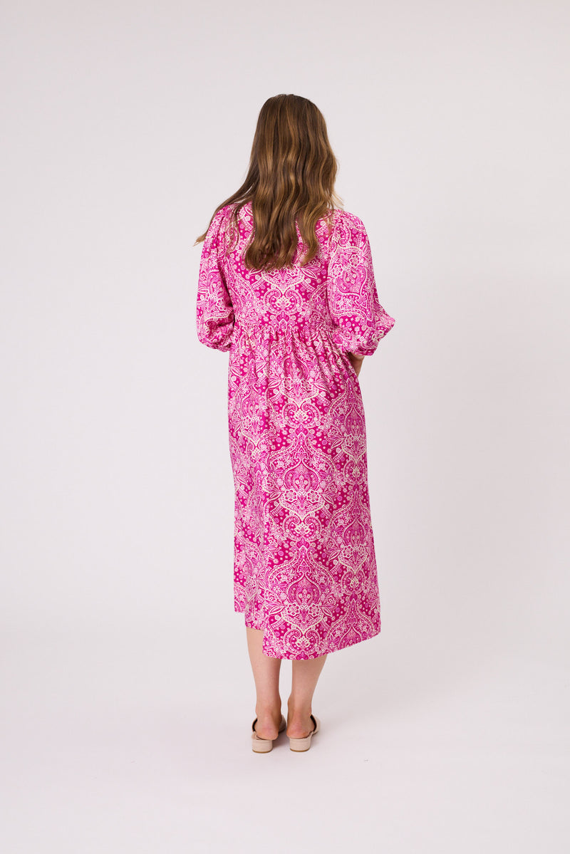 Woman wearing a pink floral dress on a white background Paisley Dress Hot Pink