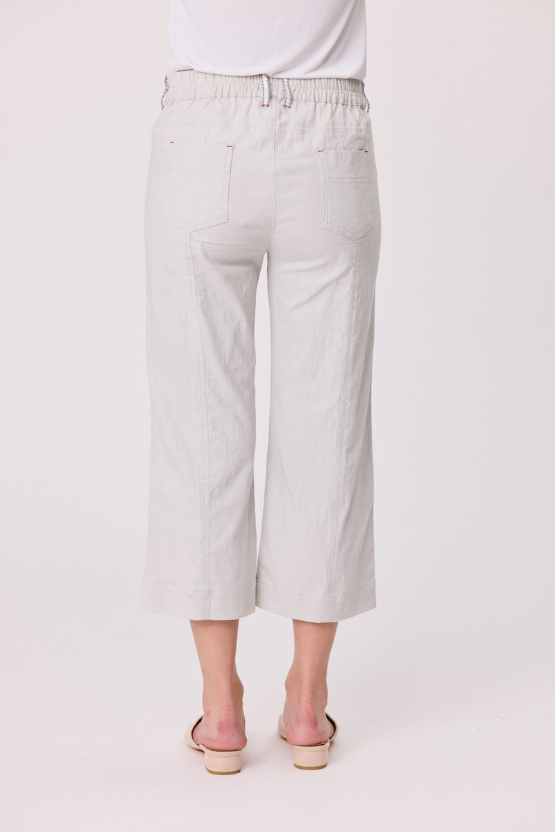 Light gray wide-leg pants worn by a person on a white background Lily 3/4 Pants Silver