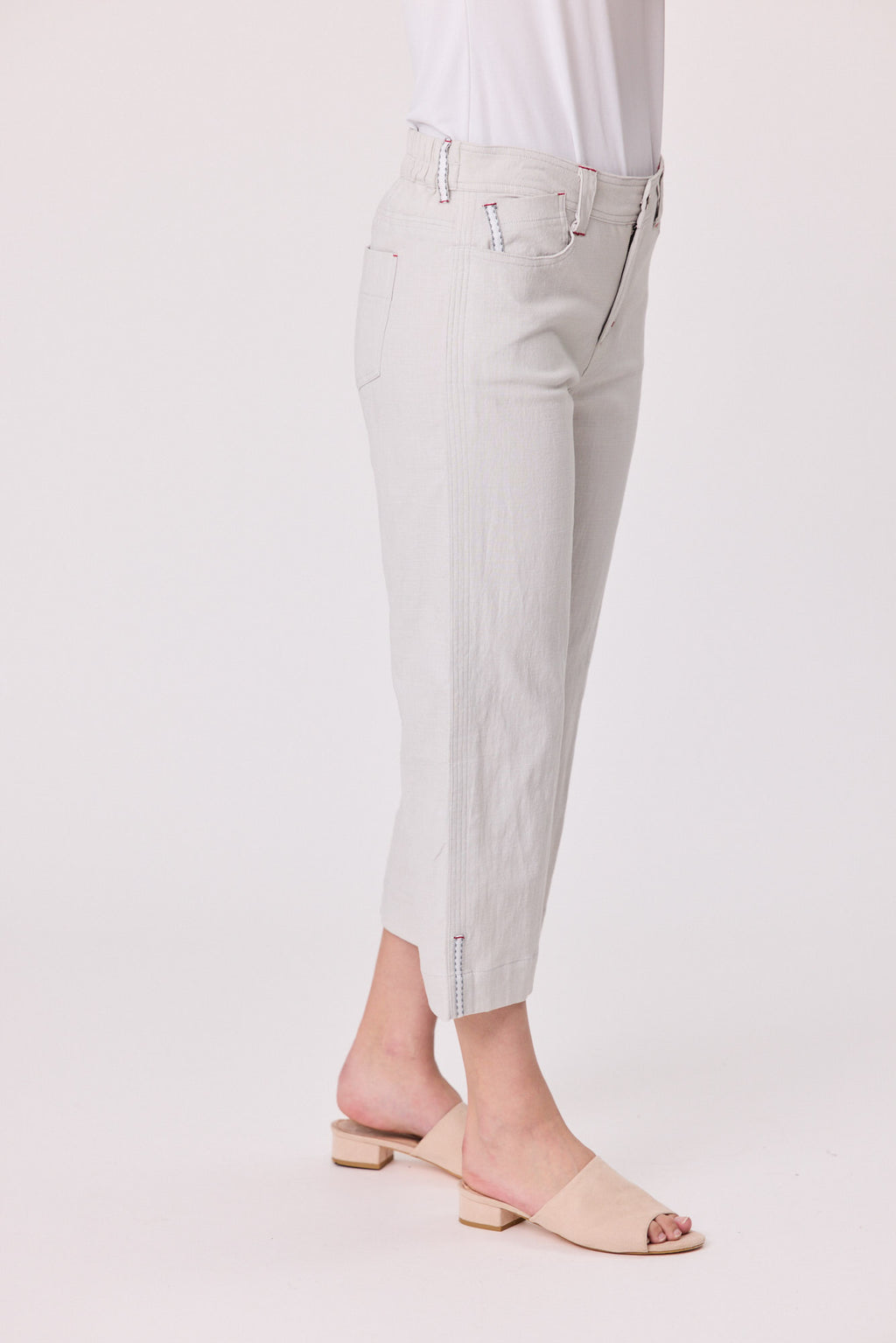 Light gray pants worn by a person on a white background Lily 3/4 Pants Silver