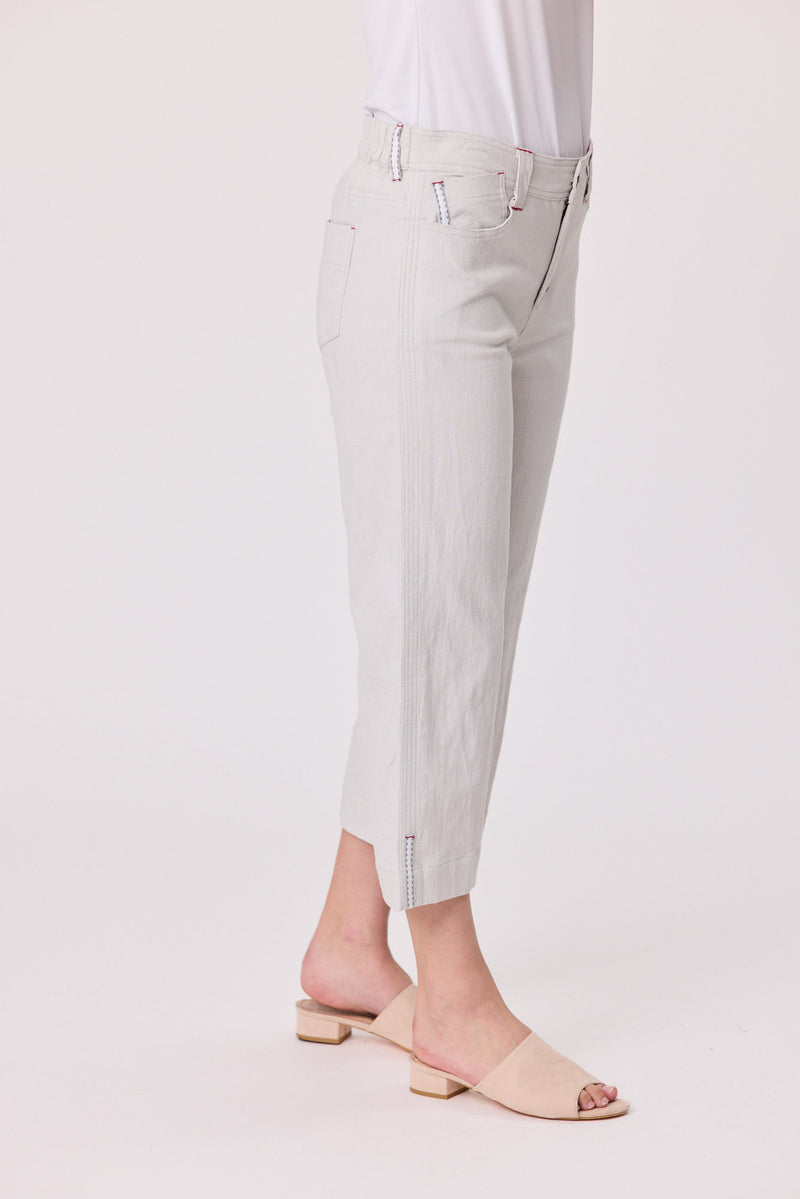 Light gray pants worn by a person on a white background Lily 3/4 Pants Silver