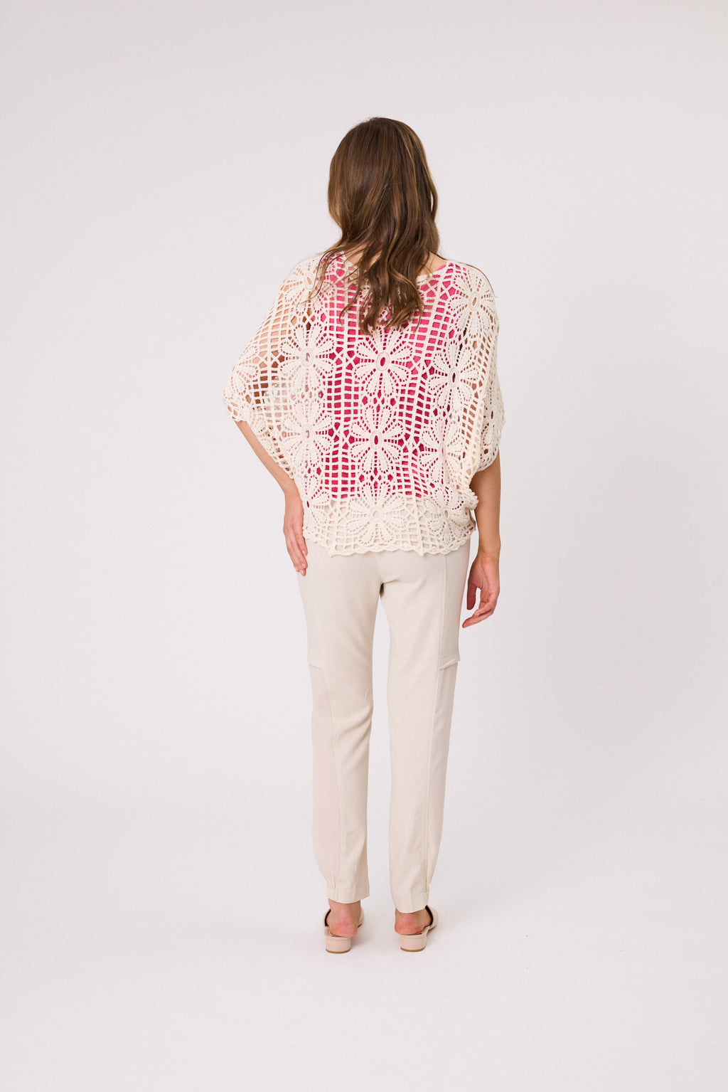 Woman wearing a patterned top and beige pants on a white background Gemma Crochet Top Natural