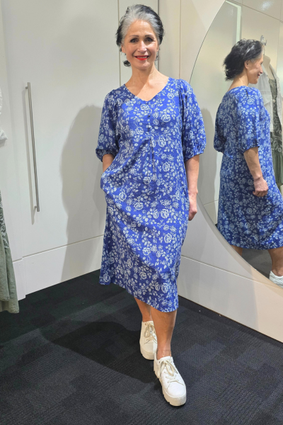 Woman wearing a blue floral dress standing in front of a mirror.
Elastic Sleeve Dress Blue