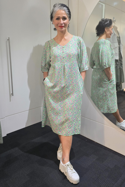 Woman wearing a green floral dress standing in front of a mirror.
Elastic Sleeve Dress Green