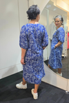 Woman wearing a blue floral dress standing in front of a mirror.
Elastic Sleeve Dress Blue