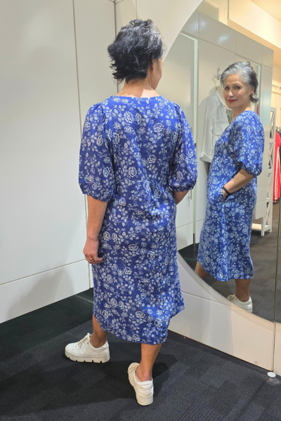 Woman wearing a blue floral dress standing in front of a mirror.
Elastic Sleeve Dress Blue