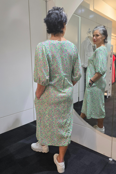 Person wearing a green floral dress standing in front of a mirror.
Elastic Sleeve Dress Green