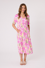 Woman wearing a pink floral dress on a white background Ella Dress White