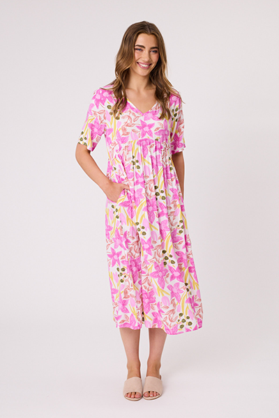 Woman wearing a pink floral dress on a white background Ella Dress White