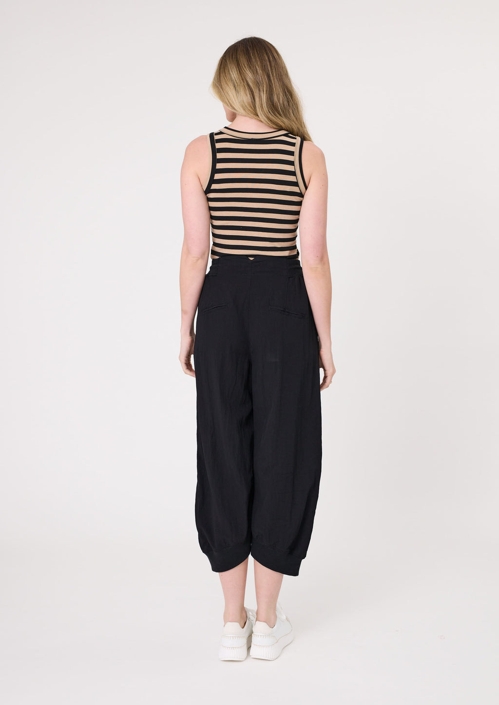Woman wearing a striped tank top and black wide-leg pants on a white background
Eva Stripe Tank Mocha/Black