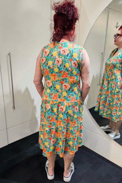 Person wearing a floral dress in front of a mirror
Everly Dress Green