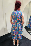 Person wearing a colorful floral dress in front of a mirror.
Everly Dress Navy