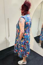 Person wearing a colorful floral dress in a bathroom setting
Everly Dress Navy