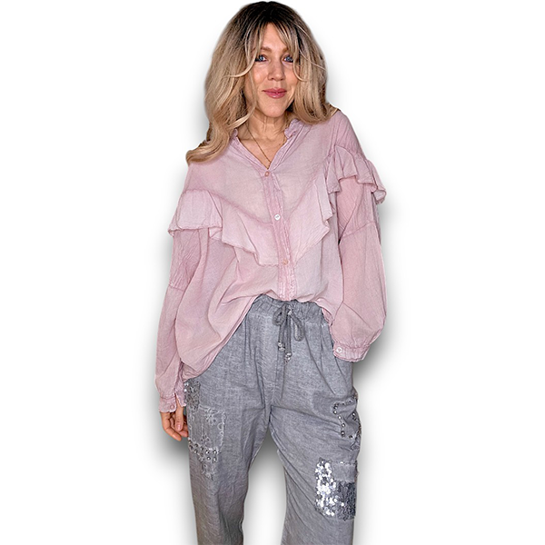 Woman wearing a pink blouse and gray pants on a white background
Frill Tunic Baby Pink