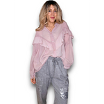 Woman wearing a pink blouse and gray pants on a white background
Frill Tunic Baby Pink