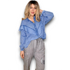 Woman wearing a blue shirt and gray pants on a white background
Frill Tunic Denim Blue