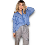 Woman wearing a blue shirt and gray pants on a white background
Frill Tunic Denim Blue