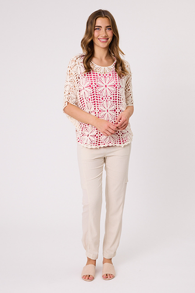 Woman wearing a patterned top and beige pants on a white background Gemma Crochet Top Natural