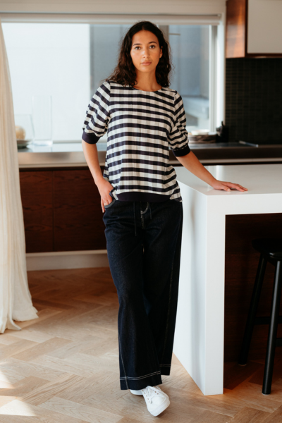 Woman standing in a modern kitchen wearing a striped shirt and black pants.
Havana Top Navy Check