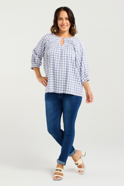 Woman wearing a blue and white checkered blouse and blue jeans on a light gray background
Hazel Top Blue Check