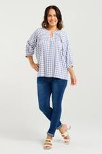 Woman wearing a blue and white checkered blouse and blue jeans on a light gray background
Hazel Top Blue Check