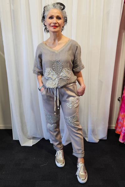 Person wearing a gray outfit with embellishments in front of white curtains
Italian Relax Heart Pants Taupe