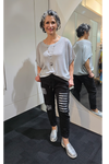 Woman in a gray oversized shirt and black ripped jeans standing in front of a mirror.
Italian Seq Pants Black