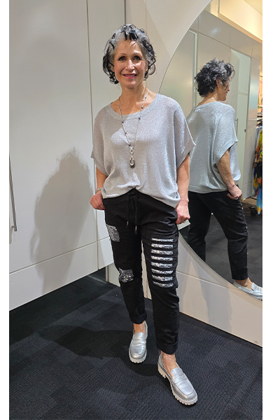 Woman in a gray oversized shirt and black ripped jeans standing in front of a mirror.
Italian Seq Pants Black