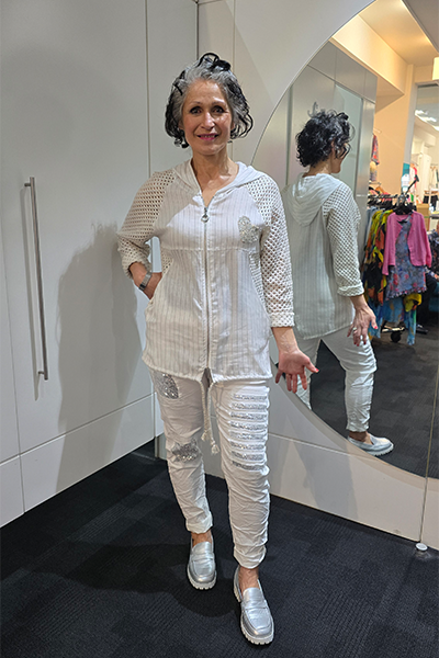 Woman in a white outfit standing in front of a mirror in a store.
Italian Seq Pants White