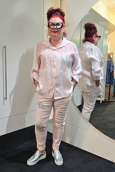 Person wearing a light-colored outfit with ripped jeans in front of a mirror.
Italian Hey Sequin Shirt Pink