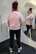 Person with pink hair wearing a light pink knitted top and black pants, standing in front of a mirror.
Italian Metallic Stars Top Pink