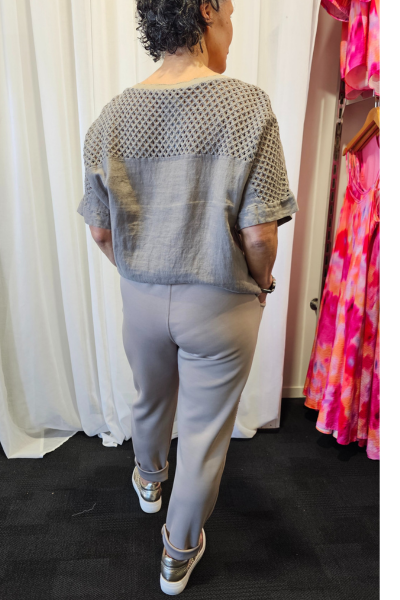 Person wearing a gray outfit with a patterned top and pants, standing in front of a white curtain.
Italian Relax Heart Pants Taupe