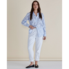Woman wearing a light blue patterned shirt and white pants against a beige background
Lace Stripe Shirt Blue