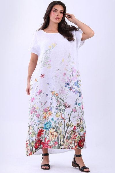 Woman wearing a white dress with colorful floral pattern on a white background
Garden Print Slouch Dress White