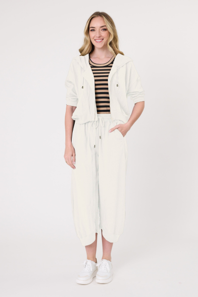Woman wearing a white outfit with a black and white striped top on a white background
Larissa Pant Antique White