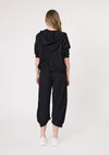 Person wearing a black hoodie and black pants on a white background
Larissa Pant Black
